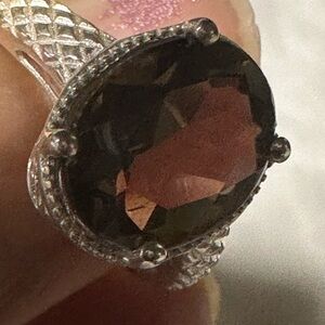 This is a sterling silver ring featuring a smoky quartz gemstone